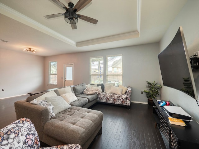 6900 Midlothian Dr, Austin, TX 78754 - living room featuring a raised ceiling, ceiling fan, dark wood-style flooring, ornamental molding, and baseboards