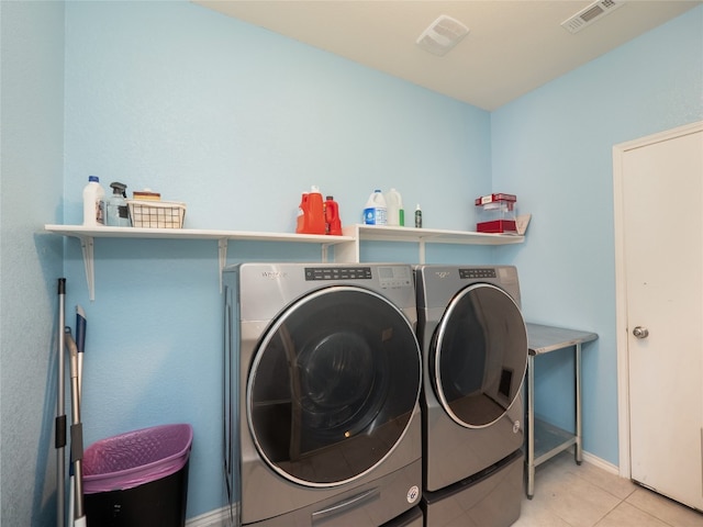 6900 Midlothian Dr, Austin, TX 78754 - washroom featuring washer and dryer, light tile patterned floors, and baseboards