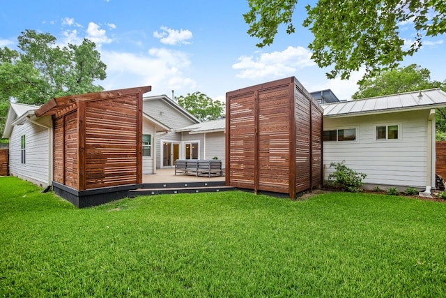 1002 Payne Ave, Austin, TX 78757 - rear view of house with a yard, metal roof, and a deck