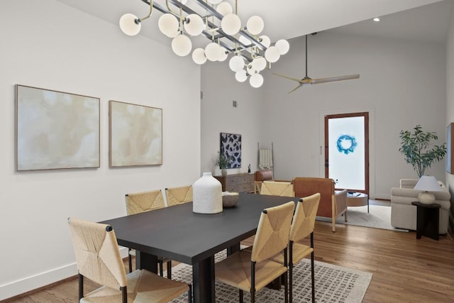 1002 Payne Ave, Austin, TX 78757 - dining room featuring wood finished floors, high vaulted ceiling, baseboards, a ceiling fan, and a chandelier