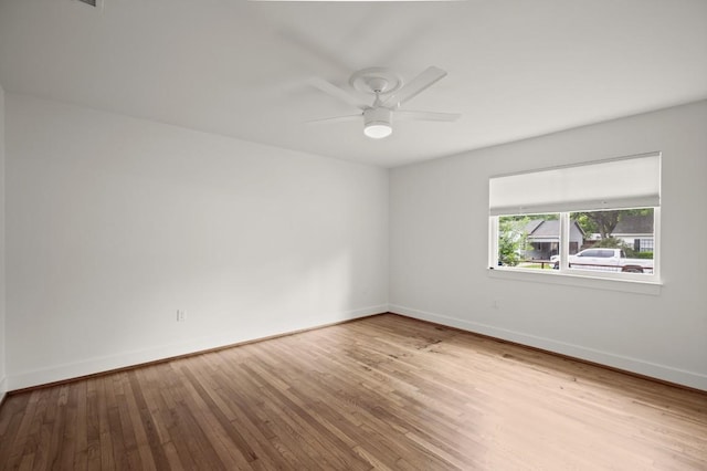 1002 Payne Ave, Austin, TX 78757 - unfurnished room featuring a ceiling fan, hardwood / wood-style floors, and baseboards
