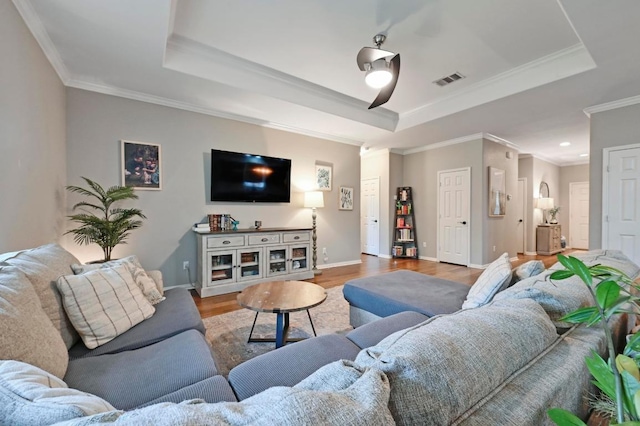 1192 Clark Brothers Dr, Buda, TX 78610 - living area with a raised ceiling, wood finished floors, baseboards, and crown molding