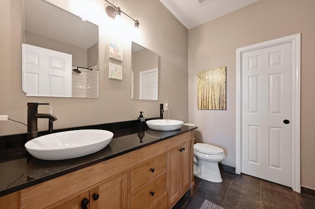 1192 Clark Brothers Dr, Buda, TX 78610 - bathroom with double vanity, toilet, a shower, and tile patterned floors