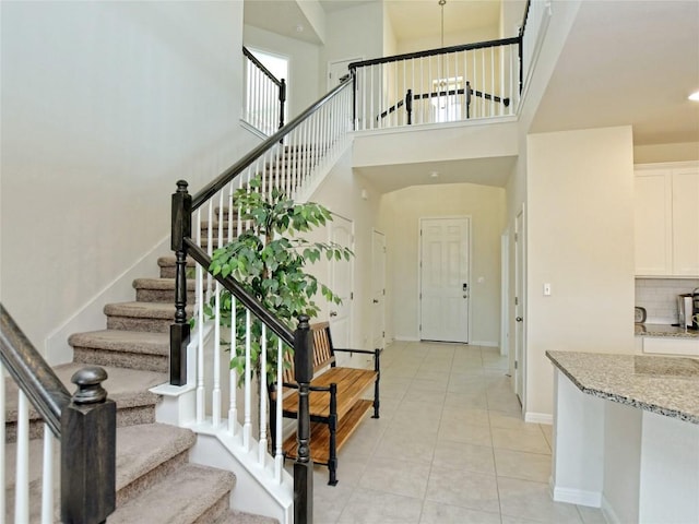 913 Swan Flower St, Leander, TX 78641 - foyer entrance with stairway, light tile patterned floors, a high ceiling, and recessed lighting