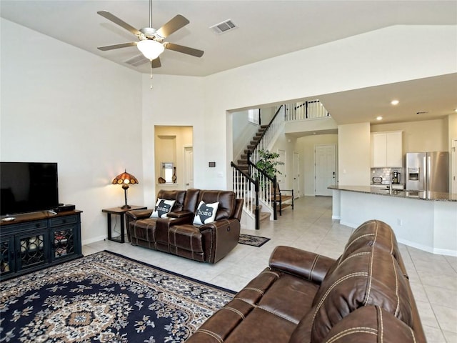 913 Swan Flower St, Leander, TX 78641 - living room featuring light tile patterned floors, a ceiling fan, stairs, vaulted ceiling, and recessed lighting