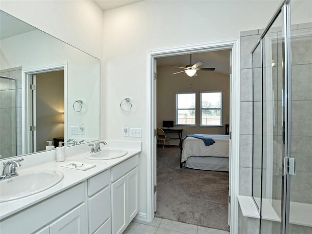 913 Swan Flower St, Leander, TX 78641 - ensuite bathroom featuring double vanity, a stall shower, ceiling fan, tile patterned floors, and vaulted ceiling