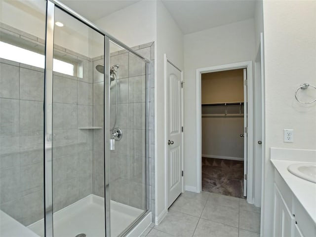 913 Swan Flower St, Leander, TX 78641 - full bath featuring a stall shower, tile patterned flooring, vanity, and a spacious closet