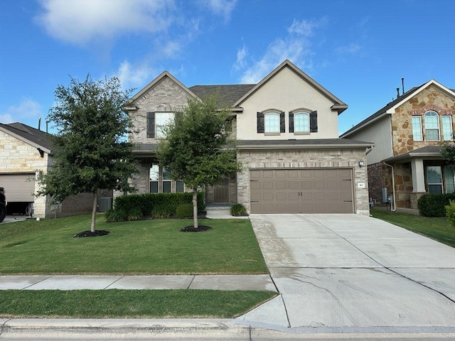 913 Swan Flower St, Leander, TX 78641 - view of front of property with concrete driveway, a front yard, a garage, and stucco siding