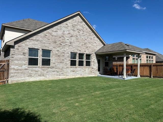 913 Swan Flower St, Leander, TX 78641 - back of house with brick siding, a patio area, and a fenced backyard
