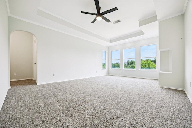 15405 Montoya Cv, Austin, TX 78717 - empty room featuring a tray ceiling, carpet flooring, a ceiling fan, arched walkways, and crown molding