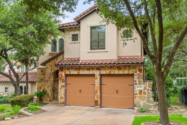 1036 Liberty Park Dr Unit 3, Austin, TX 78746 - mediterranean / spanish house featuring an attached garage, stone siding, a tiled roof, driveway, and stucco siding