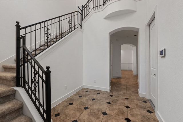 1036 Liberty Park Dr Unit 3, Austin, TX 78746 - stairway featuring arched walkways and tile patterned floors