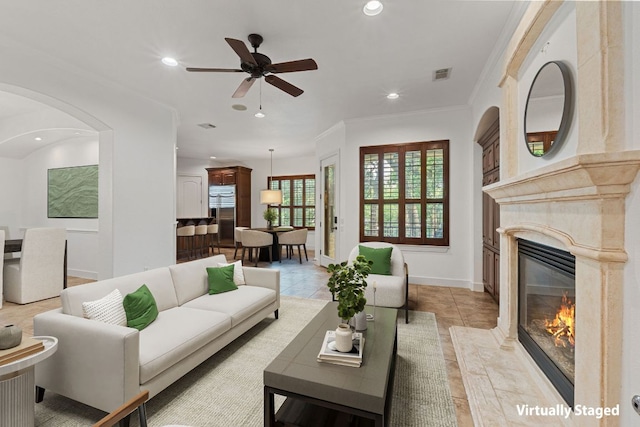 1036 Liberty Park Dr Unit 3, Austin, TX 78746 - living area featuring a ceiling fan, a premium fireplace, recessed lighting, ornamental molding, and arched walkways