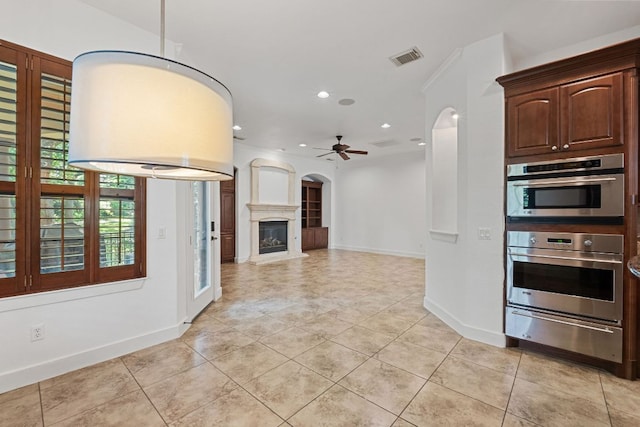 1036 Liberty Park Dr Unit 3, Austin, TX 78746 - kitchen featuring a warming drawer, light tile patterned floors, a ceiling fan, arched walkways, and recessed lighting