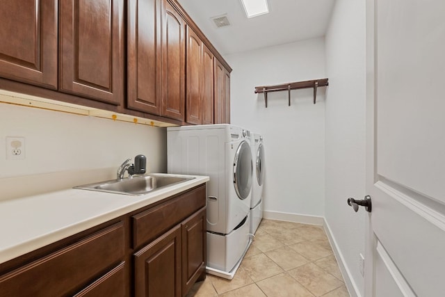 1036 Liberty Park Dr Unit 3, Austin, TX 78746 - laundry area featuring washer and clothes dryer, cabinet space, and light tile patterned flooring