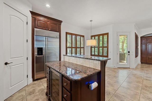 1036 Liberty Park Dr Unit 3, Austin, TX 78746 - kitchen featuring stainless steel built in fridge, beverage cooler, a kitchen island, dark stone countertops, and dark brown cabinetry