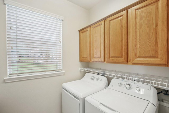 6611 Haughton Dr, Spring, TX 77389 - washroom with separate washer and dryer and cabinet space