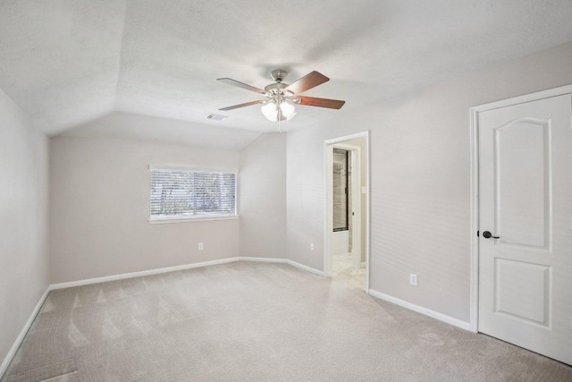 6611 Haughton Dr, Spring, TX 77389 - unfurnished bedroom with light carpet, baseboards, lofted ceiling, ensuite bath, and ceiling fan