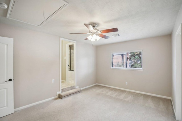 6611 Haughton Dr, Spring, TX 77389 - carpeted spare room with attic access, baseboards, and a ceiling fan