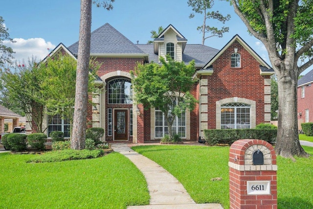 6611 Haughton Dr, Spring, TX 77389 - view of front of property featuring brick siding, a front lawn, and a shingled roof