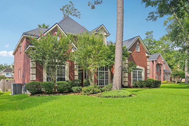 6611 Haughton Dr, Spring, TX 77389 - traditional-style house with brick siding and central AC