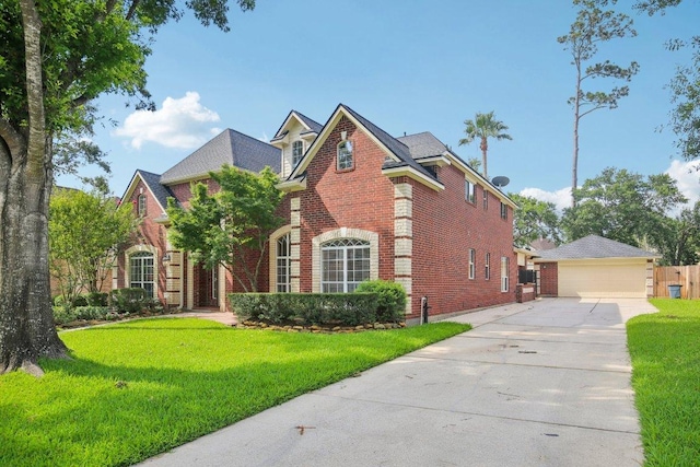 6611 Haughton Dr, Spring, TX 77389 - view of front facade featuring brick siding and a detached garage