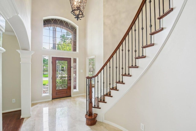 6611 Haughton Dr, Spring, TX 77389 - entrance foyer featuring a towering ceiling, healthy amount of natural light, baseboards, and stairs