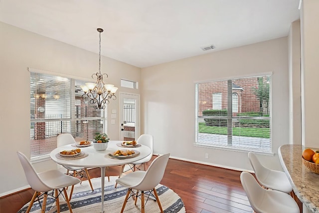 6611 Haughton Dr, Spring, TX 77389 - dining room with healthy amount of natural light, dark wood finished floors, baseboards, and a chandelier