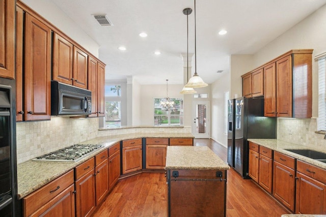 6611 Haughton Dr, Spring, TX 77389 - kitchen with black appliances, a peninsula, dark wood finished floors, recessed lighting, and tasteful backsplash