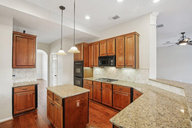 6611 Haughton Dr, Spring, TX 77389 - kitchen with black appliances, arched walkways, dark wood-type flooring, ceiling fan, and backsplash