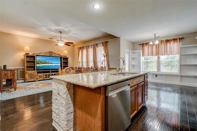 3107 Magnolia Mnr, New Braunfels, TX 78130 - kitchen with stainless steel dishwasher, a sink, dark wood-type flooring, plenty of natural light, and a wainscoted wall