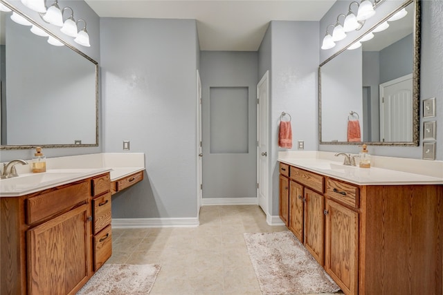 3107 Magnolia Mnr, New Braunfels, TX 78130 - bathroom featuring two vanities, baseboards, and tile patterned flooring