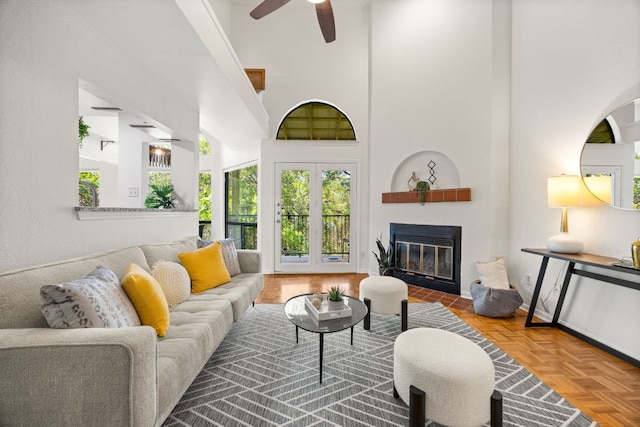 3840 Far W Blvd Unit 213, Austin, TX 78731 - living room with a towering ceiling, a fireplace with flush hearth, and a ceiling fan