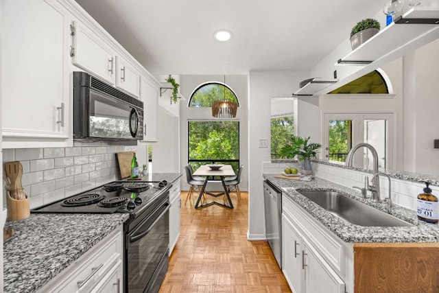 3840 Far W Blvd Unit 213, Austin, TX 78731 - kitchen with black appliances, white cabinets, decorative backsplash, light stone countertops, and recessed lighting