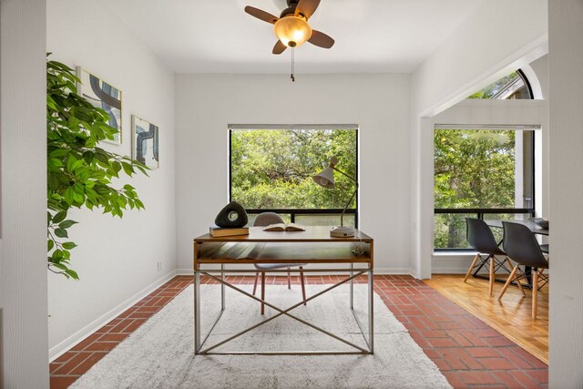 3840 Far W Blvd Unit 213, Austin, TX 78731 - home office featuring brick flooring, baseboards, and ceiling fan