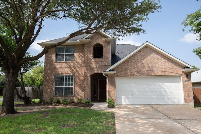 2308 Lou John St, Austin, TX 78727 - traditional-style house featuring an attached garage, driveway, brick siding, and roof with shingles