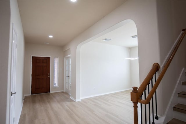 2308 Lou John St, Austin, TX 78727 - entryway featuring arched walkways, light wood-style flooring, recessed lighting, stairway, and baseboards