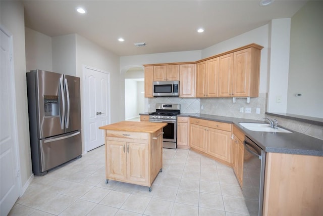 2308 Lou John St, Austin, TX 78727 - kitchen with stainless steel appliances, a sink, wooden counters, arched walkways, and backsplash