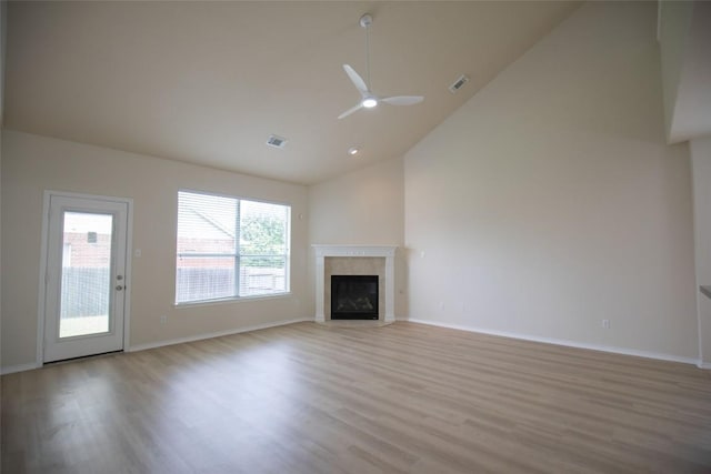 2308 Lou John St, Austin, TX 78727 - unfurnished living room with light wood finished floors, high vaulted ceiling, a high end fireplace, a ceiling fan, and baseboards
