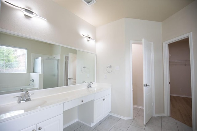 2308 Lou John St, Austin, TX 78727 - bathroom with a stall shower, double vanity, a garden tub, a walk in closet, and tile patterned flooring