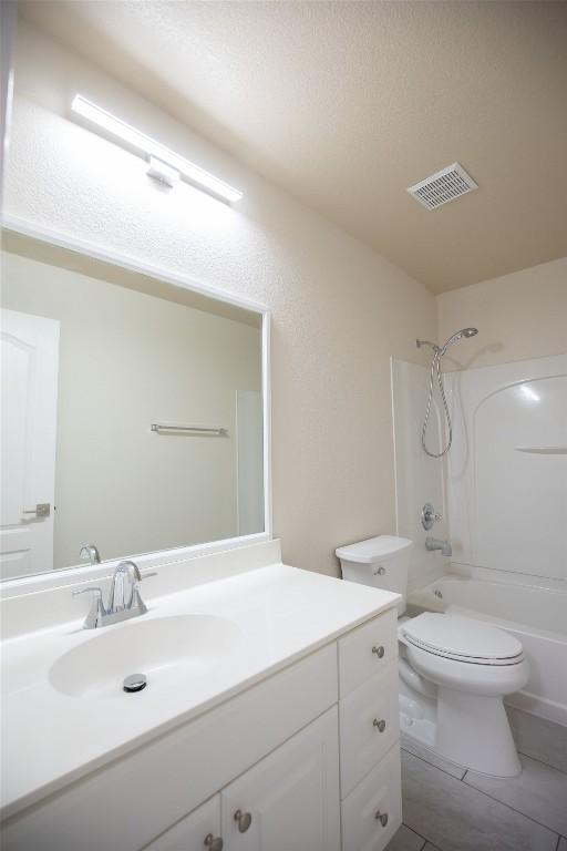 2308 Lou John St, Austin, TX 78727 - bathroom with vanity, toilet, shower / bathtub combination, and tile patterned floors