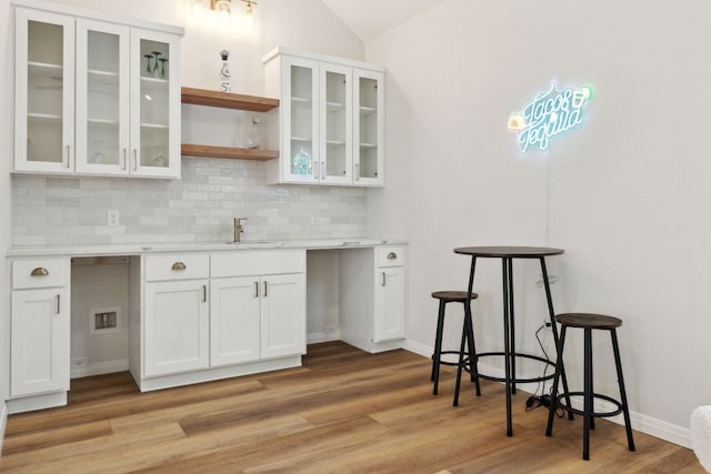 800 Newcastle Dr, Austin, TX 78745 - bar with tasteful backsplash, light wood-style floors, and vaulted ceiling