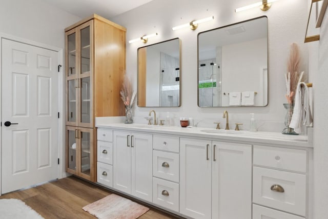800 Newcastle Dr, Austin, TX 78745 - bathroom with double vanity, wood finished floors, and a shower