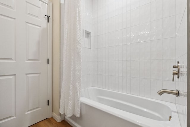 800 Newcastle Dr, Austin, TX 78745 - full bath featuring shower / bath combo with shower curtain and wood finished floors