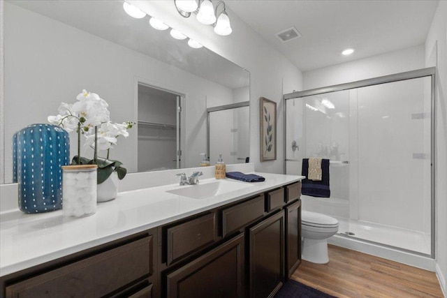 336 Wonderful Life Way, Jarrell, TX 76537 - full bath featuring a shower stall, wood finished floors, vanity, toilet, and a walk in closet
