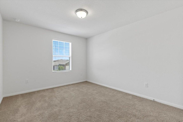 336 Wonderful Life Way, Jarrell, TX 76537 - empty room with carpet flooring, a smoke detector, and baseboards