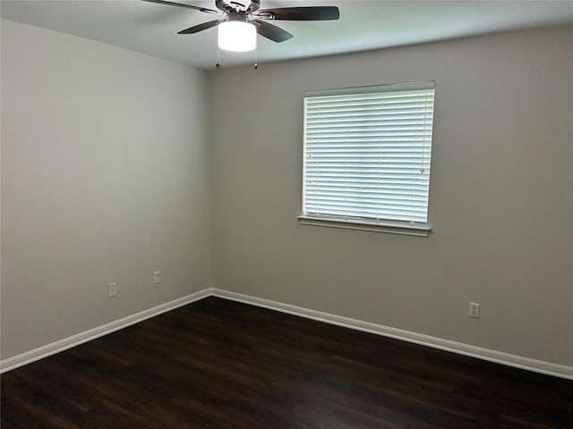 7702 Squirrel Hollow Dr, Georgetown, TX 78628 - spare room featuring dark wood-type flooring, a ceiling fan, and baseboards