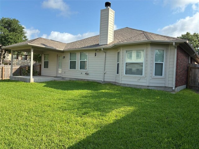 7702 Squirrel Hollow Dr, Georgetown, TX 78628 - rear view of property with a chimney, a patio area, brick siding, and a shingled roof