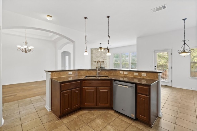 250 Maeves Way, Austin, TX 78737 - kitchen featuring dishwasher, a sink, light tile patterned floors, dark stone counters, and tasteful backsplash