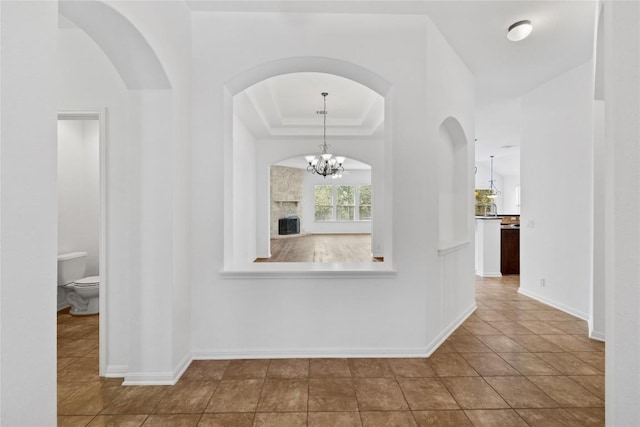 250 Maeves Way, Austin, TX 78737 - corridor featuring arched walkways, tile patterned floors, and baseboards